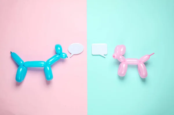 balloons in the shape of dog with speech bubbles on blue pink background. Dialogue, discussion. Top view