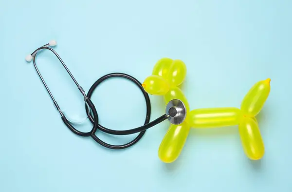 Veterinary medicine. Balloon dog with stethoscope on blue background
