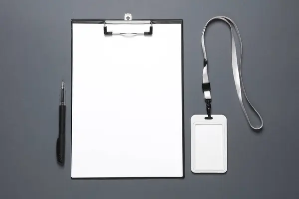 Clipboard with pen and id card on belt, dark background. Template for design. Sociological survey