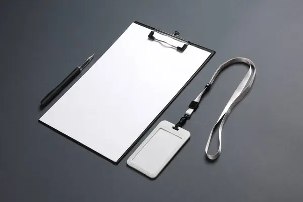Clipboard with pen and id card on belt, dark background. Template for design. Sociological survey