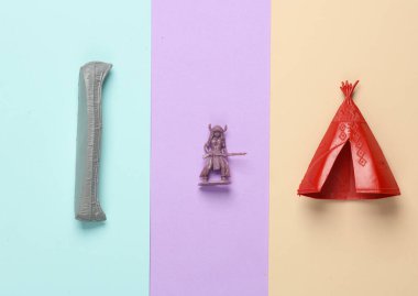 Plastik Amerikan askeri, Wigwam ve kano pastel arka planda. Yaratıcı yerleşim