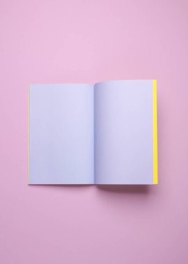 Pembe pastel arka planda mor sayfalı boş bir defter ya da defter