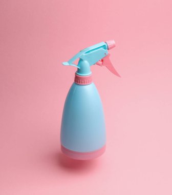 Pembe arka planda süzülen, gölgeli sprey şişesi.