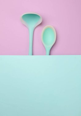 Pastel arka planda silikon mutfak aletleri. Üst görünüm