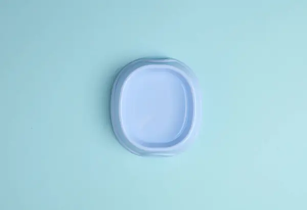 Bowl of water for drinking pets on a blue background