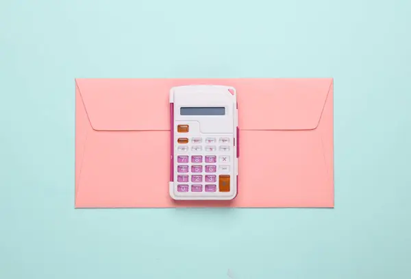 Calculator with envelope on blue background. Business concept