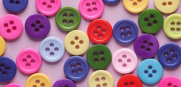 Many colored plastic buttons close-up