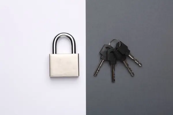 Metal lock with keys on white gray background