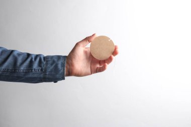 Kot gömlekli bir adam gri arka planda el işi etiketi tutuyor. Satış konsepti