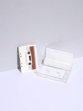 Retro 80s white audio cassette with box on white background with shadow. Creative layout, minimalism, music lover clipart