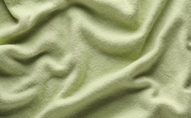 Yeşil dalgalı yün örgü süveter dokusu