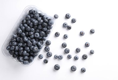 Beyaz arka planda plastik bir kutuda yabanmersini. Üst görünüm