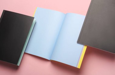 Pembe arkaplandaki not defterlerinin kompozisyonu