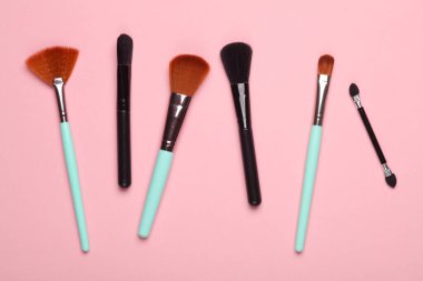 pembe arka planda makyaj fırçaları