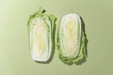 Yeşil arka planda gölgeli iki Çin lahanası. En az gıda konsepti