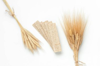 Diet bread and wheat spikelets on a white background clipart