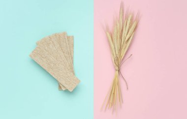 Dietary bread with wheat ears in a blue-pink background clipart