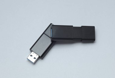 Gri arkaplanda iki siyah USB flaş bellek