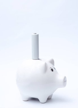 Piggy bank with AA battery on a white background clipart