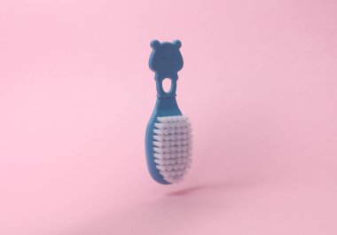 Floating Hairbrush for newborn on a pink background clipart