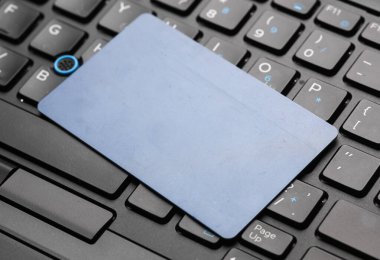 Laptop klavyesinde mavi kredi kartı.