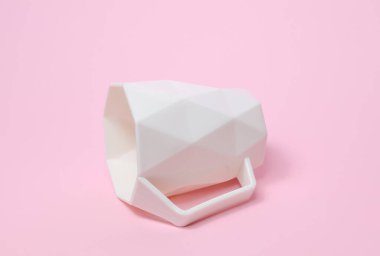 Pembe arka planda geometrik şekilli beyaz bardak