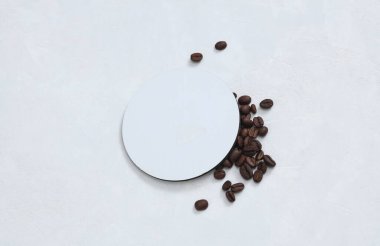White round empty coaster Mockup with coffee beans on white concrete background