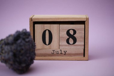 Tahta blok takvimi, tarihi Temmuz 08 ve bir buket kuru lavanta.