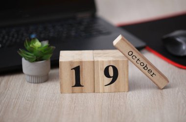 Tarihi 19 Ekim olan ahşap takvim dizüstü bilgisayarda