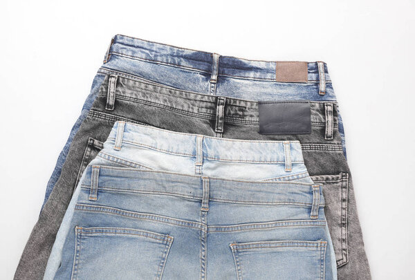 Assortment of different jeans on a white background