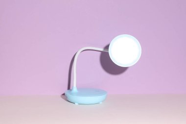Mor arkaplanda masaüstü kablosuz esnek LED lambası