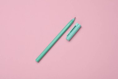 Pembe arka planda yeşil kalem. Üst görünüm