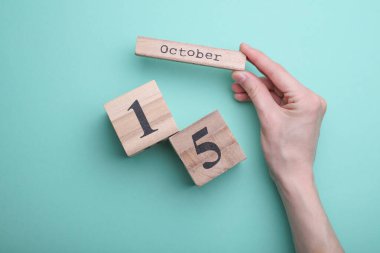 Nane yeşili arkaplanda tarihi 15 Ekim olan tahta blok takvimi