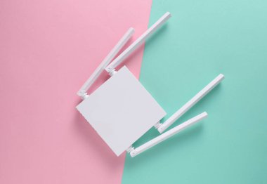 Pembe arka planda modern dört antenli Wi-Fi yönlendirici. Üst görünüm