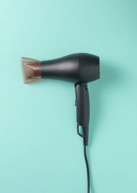 Mavi arka planda modern siyah saç kurutma makinesi