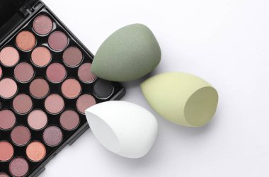 Göz farı paleti ve beyaz arka planda makyaj süngeri
