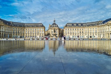 Bordeaux, France - August 17, 2019: Tourists in the famous Water Mirror in the Stock Exchange square area