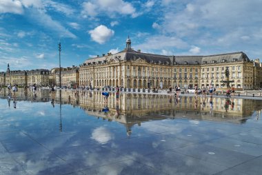 Bordeaux, France - August 17, 2019: Tourists in the famous Water Mirror in the Stock Exchange square area