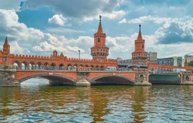 Berlin, Almanya, ünlü Oberbaum Köprüsü bulutlu bir günde Spree Nehri 'ni geçiyor.