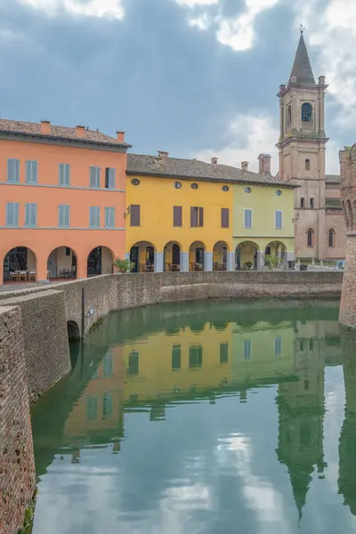 stock image Fontanellato, Italy, reflections on the moat of the fortress of the colorful houses of the vollage