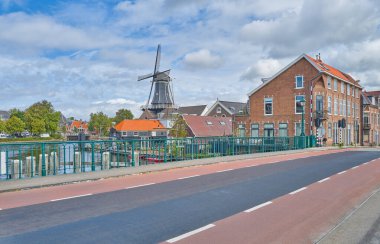 Haarlem, Holland,the village with the Adriaan windmill seen from the Catherine swing bridge on the Spaarne river, clipart