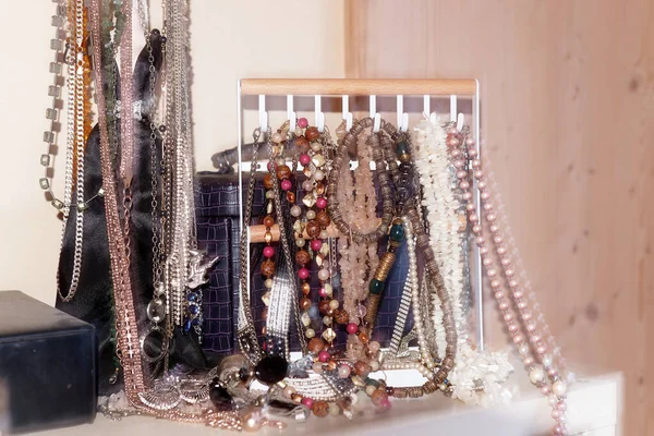 Costume jewelry, numerous chains on a jewelry stand