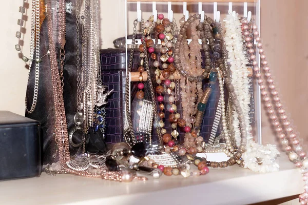 Costume jewelry, numerous chains on a jewelry stand