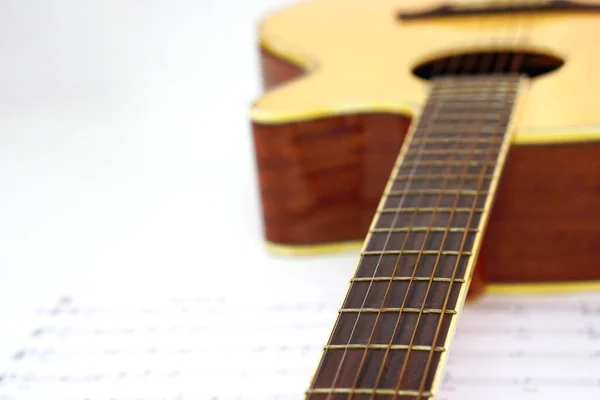 Acoustic guitar with music notes against white background and selective focus. Love and music concept. Love and music concept.