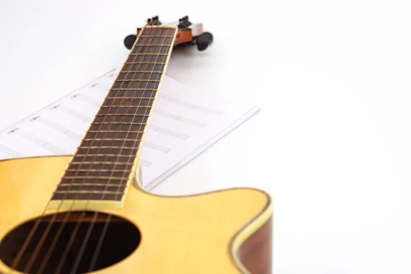 Acoustic guitar with music notes against white background. Entertainment, love and music concept.