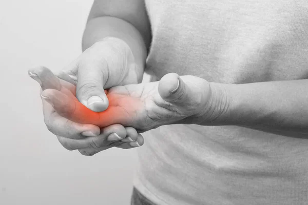 stock image Woman touching her knuckle for the pain with red inflammation effect. Healthcare and office syndrome concept.