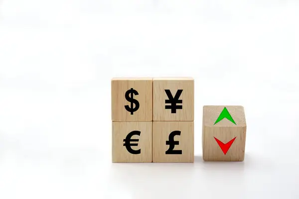 The exchange rate icon on wooden block cubes and arrows show lowering and increasing according to the index exchange rate.