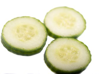 Homemade chopped cucumber.Fresh organic cucumber isolated on white background. File contains clipping path. Full depth of field.,