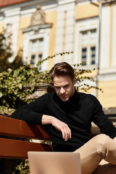 A handsome man walks by stunning architecture, focused on his phone, relaxed and happy. — Stock Photo