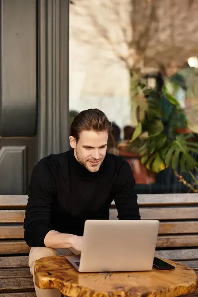 A man strolls confidently through a lively area with trees and modern architecture around him. — Stock Photo